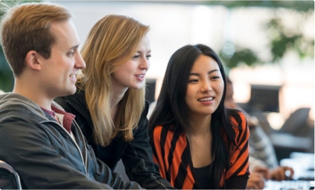 3 students looking at computer screen