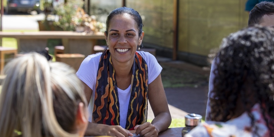 Aboriginal woman at table with other students