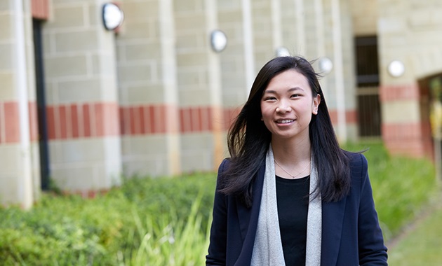 International student Andra Julinar smiling and posing in front of building at Murdoch Perth campus