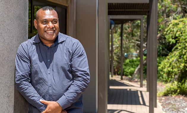 PNG student Benson Hahambu smiling outside