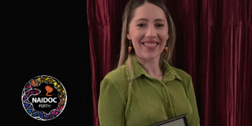 Dr Bep Uink holding her NAIDOC runner up award