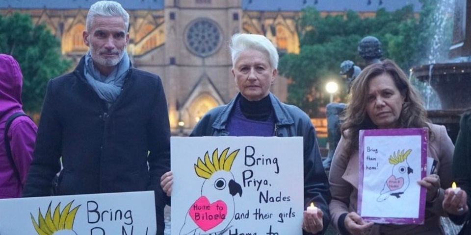 Protesters holding placards to support the Murugappan family