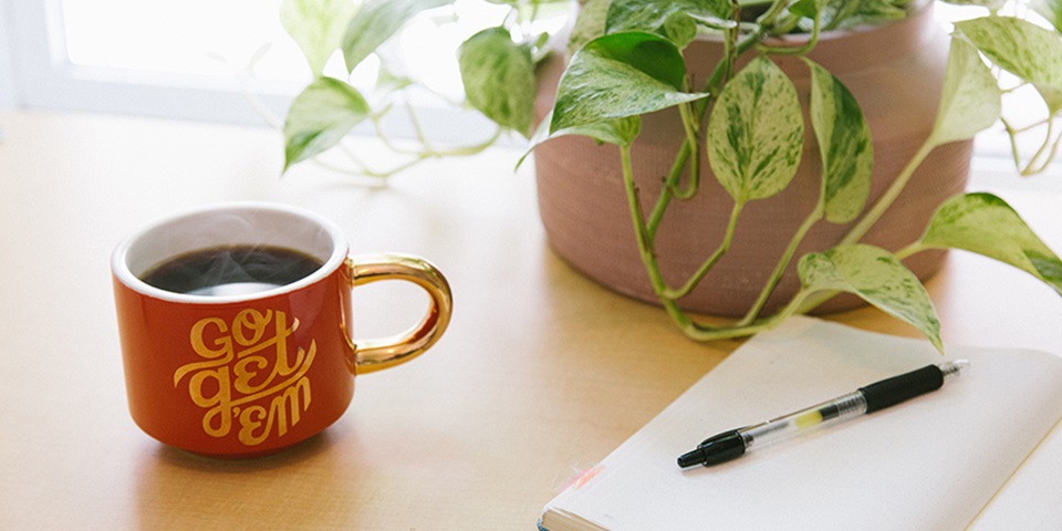 Coffee mug, notebook and pen