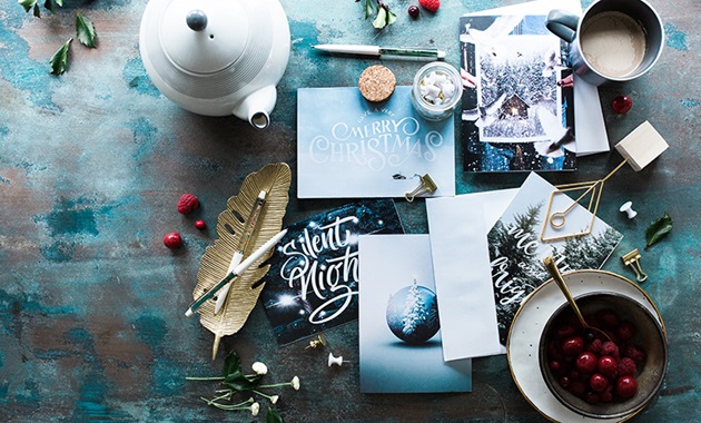 Overlay of Christmas arts and crafts spread over a table