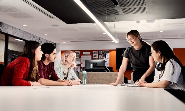 Murdoch students chatting around a table.