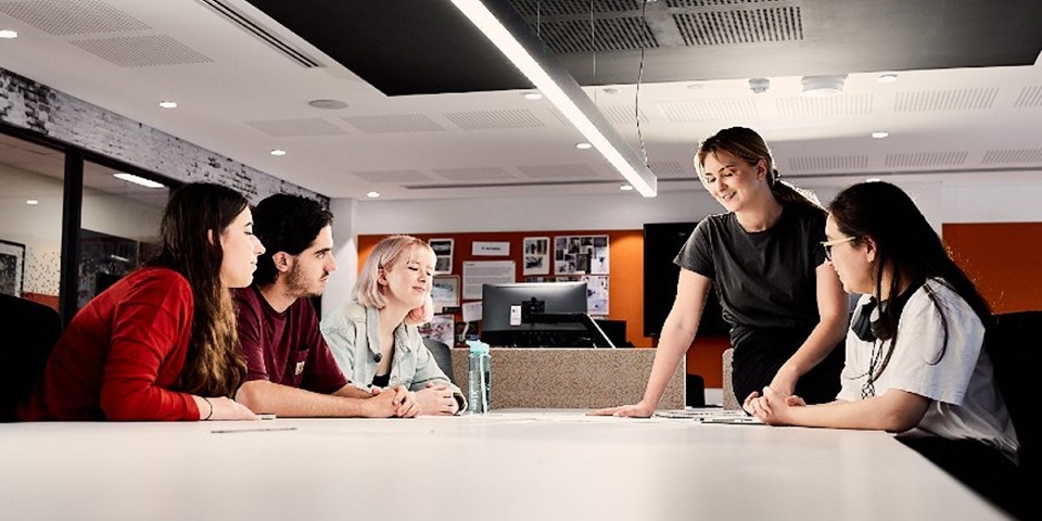 Murdoch students chatting around a table.