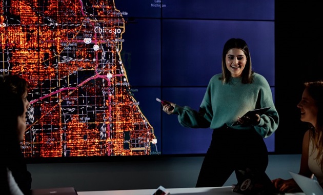 Female student presenting in front of a map of Chicago