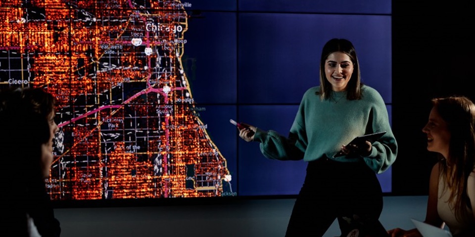 Female student presenting in front of a map of Chicago