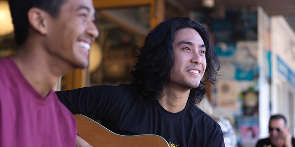 Daniel playing guitar with a friend