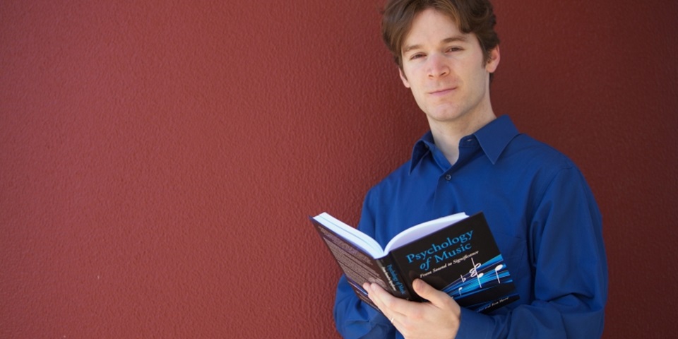 Dr Jon Prince reading a music psychology book.