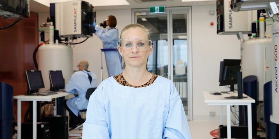 Scientist smiling at camera in lab