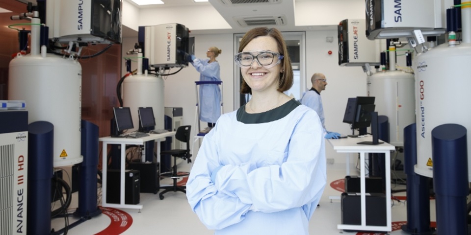 Dr Nicola Gray stands in front of the NMR suite at the Australian National Phenome Centre