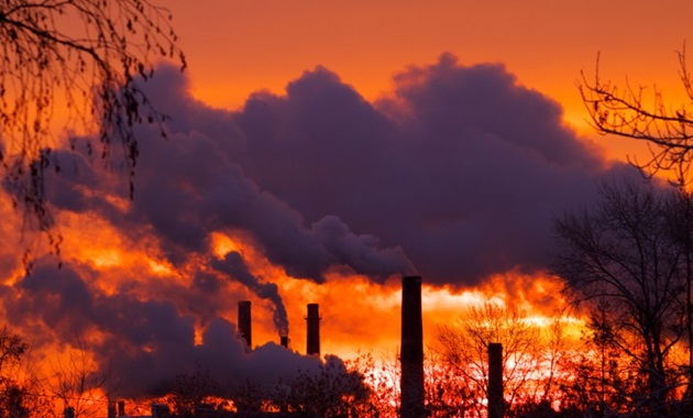 Emissions from smoke stacks at sunset