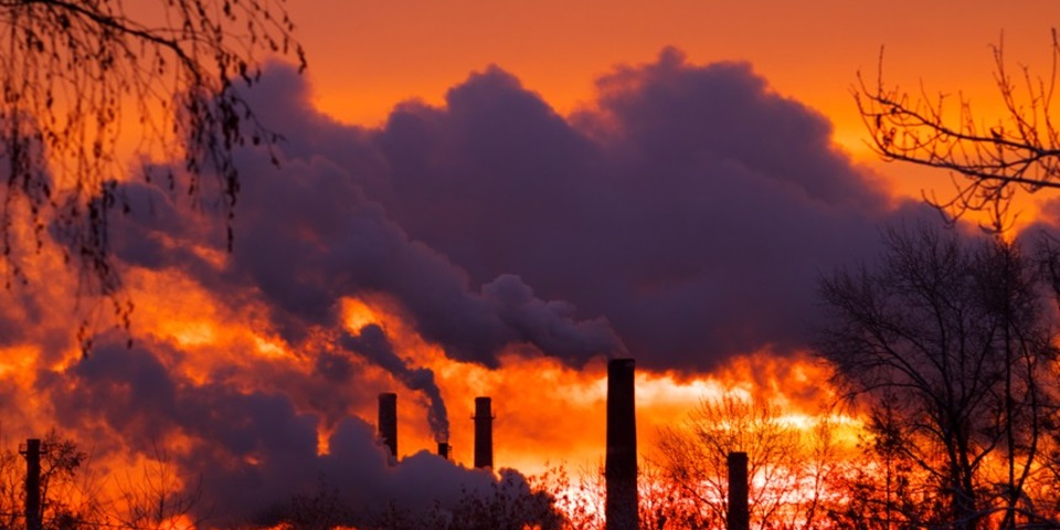 Emissions from smoke stacks at sunset