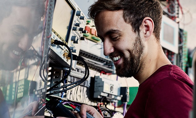 Smiling man works on switchboard.