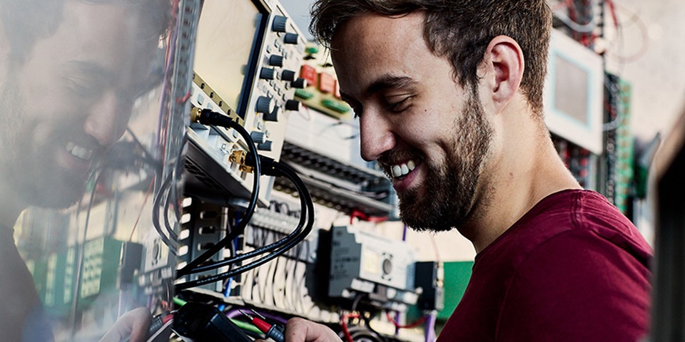 Smiling man works on switchboard.