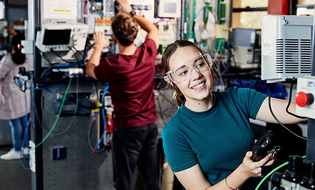 Female student works in engineering lab.