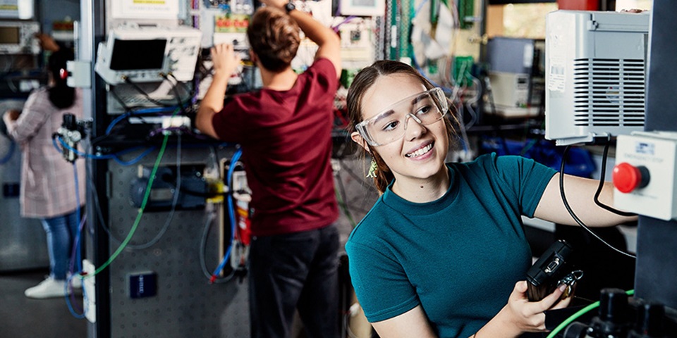 Female student works in engineering lab.