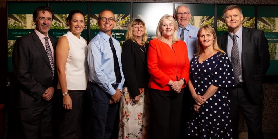 Professor Elaine Holmes with researchers and the minister