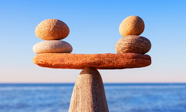 Pebbles balancing against an ocean backdrop