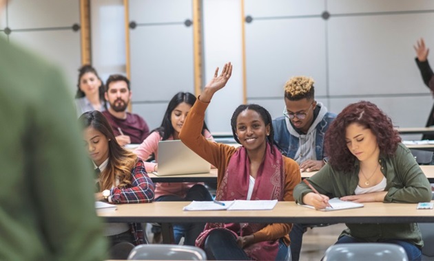 Class of students asking their teacher questions