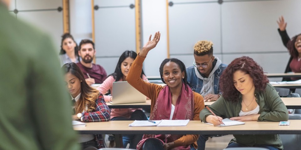 Class of students asking their teacher questions