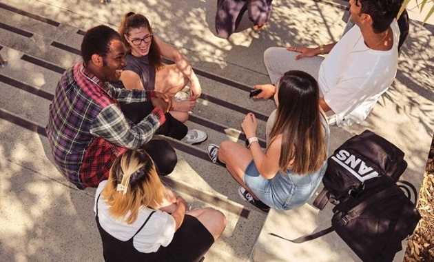 Group of teens sitting together in a circle