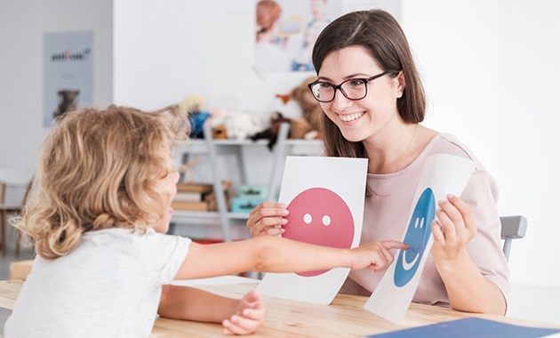 Psychologist working with child in education room