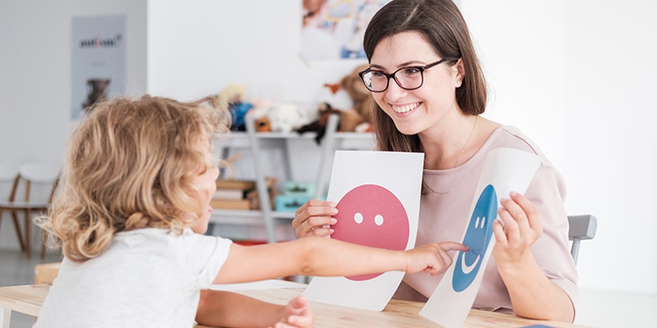 Psychologist working with child in education room