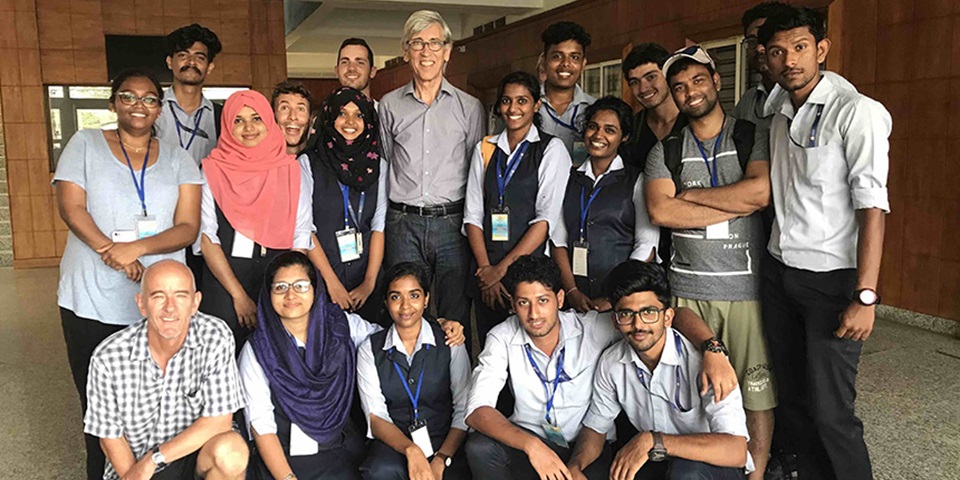 Group of students and lecturers posing and smiling