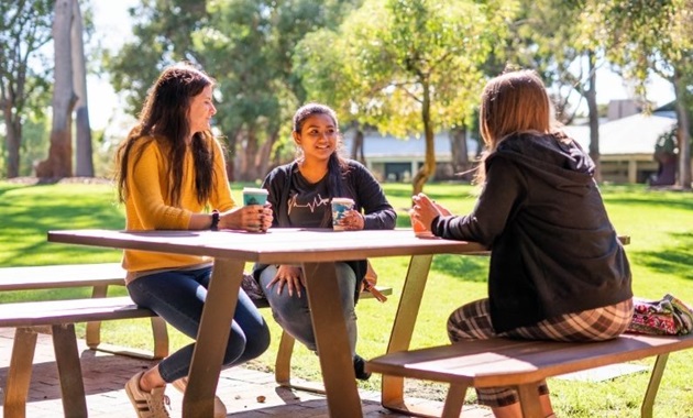 Students sitting at picnic table