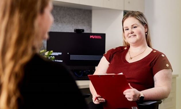 Student counsellor smiles at client