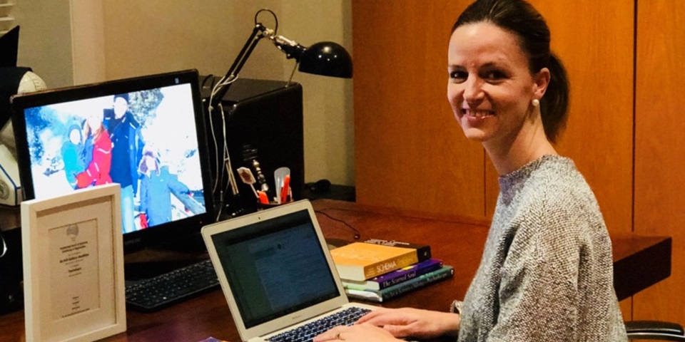 Kelli MacMillan at desk