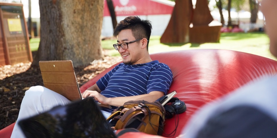 man studying in bush court