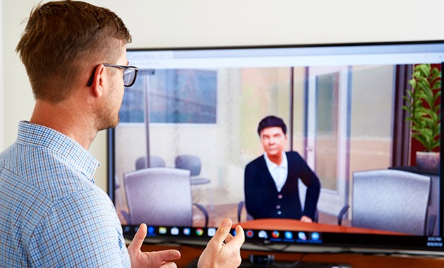 Man talking to computer screen