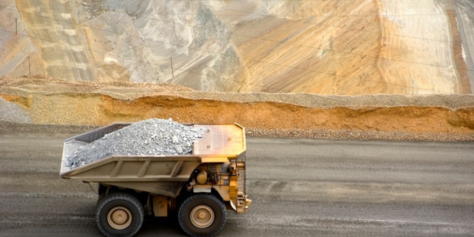 mining dump truck drives through copper mine