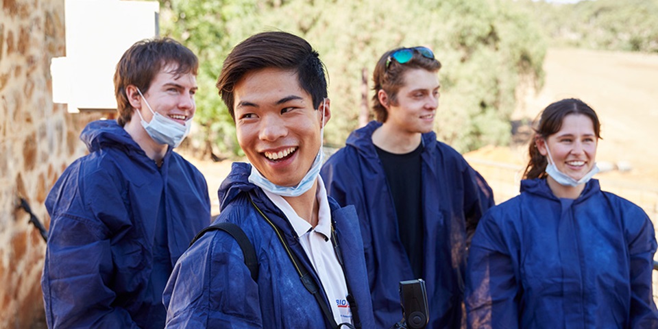 Murdoch students in the field wearing protective gear.