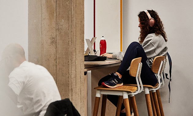 Woman studying for exams with headphones on