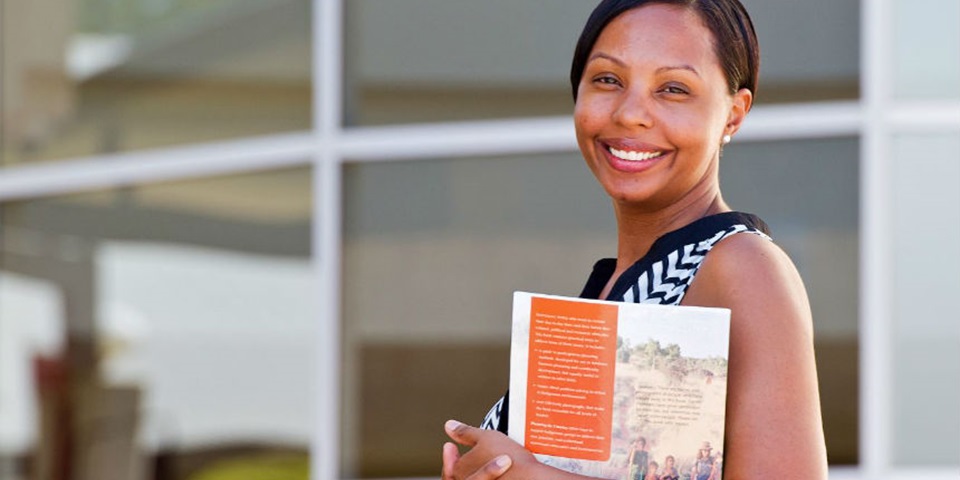 Smiling mature female student with brochure