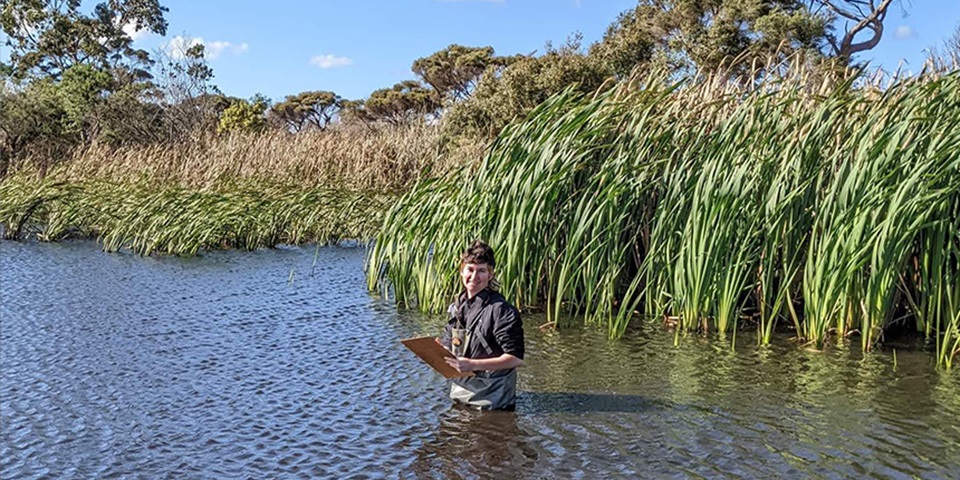 Jemma Goss standing in the middle of swamp water