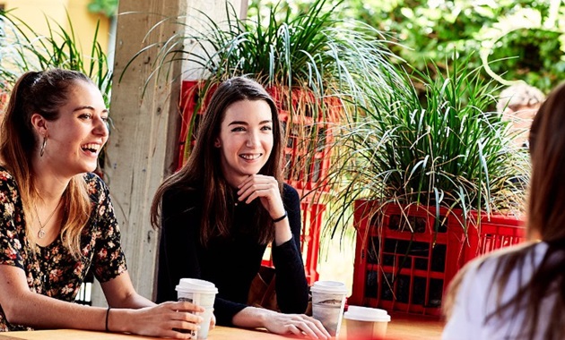 Female students talking over coffee