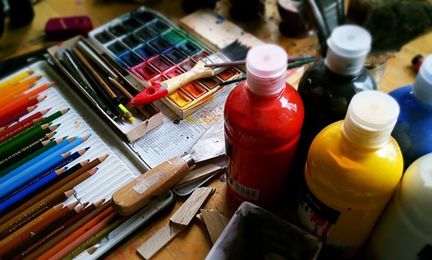 Painting supplies scattered on a table