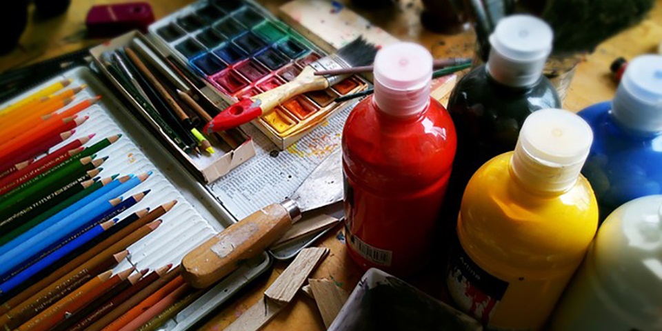 Painting supplies scattered on a table