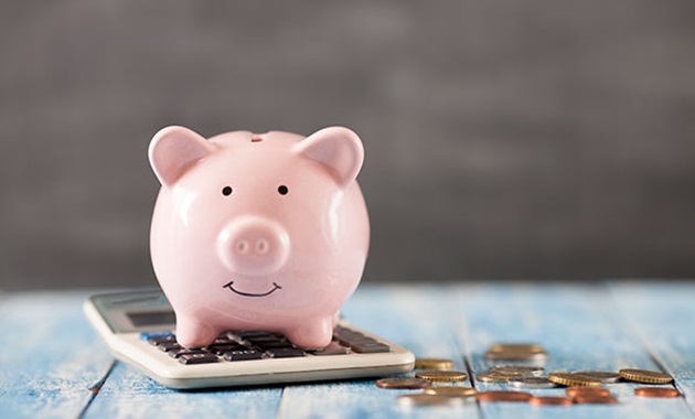 Piggy bank coins and a calculator