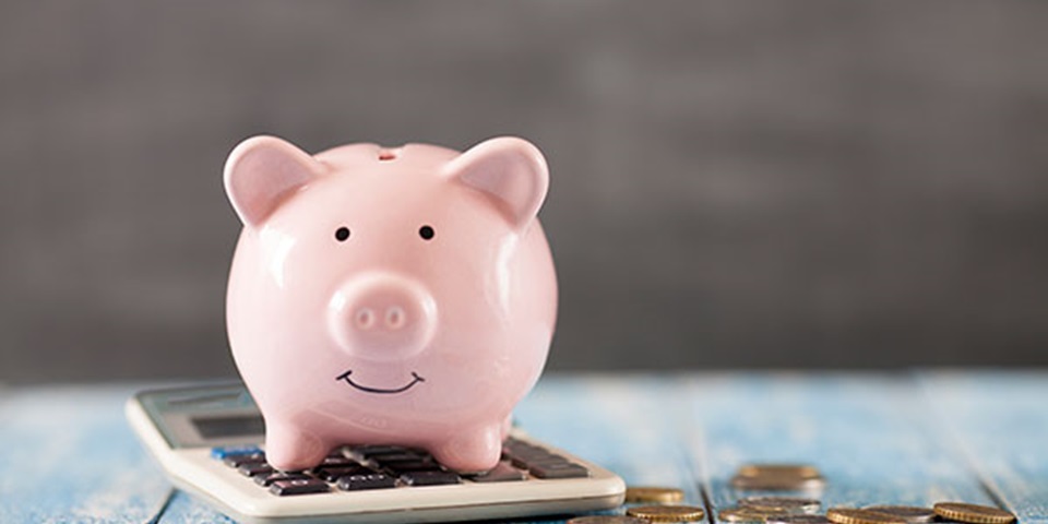 Piggy bank coins and a calculator