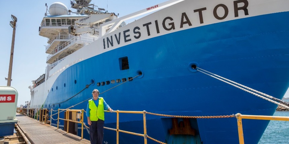 Professor Lynnath Beckley in front of the RV Investigator