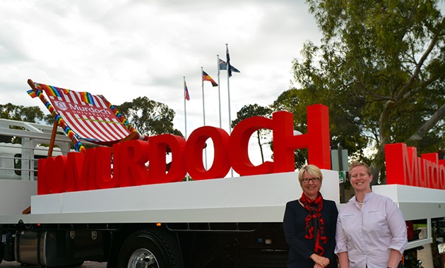 Professors Eeva Leinonen and Romy Lawson in front of Murdoch pride float