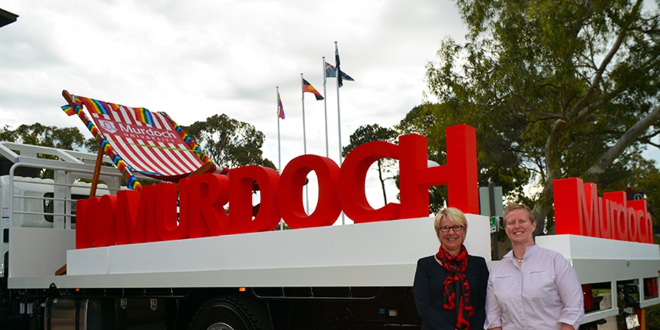 Professors Eeva Leinonen and Romy Lawson in front of Murdoch pride float