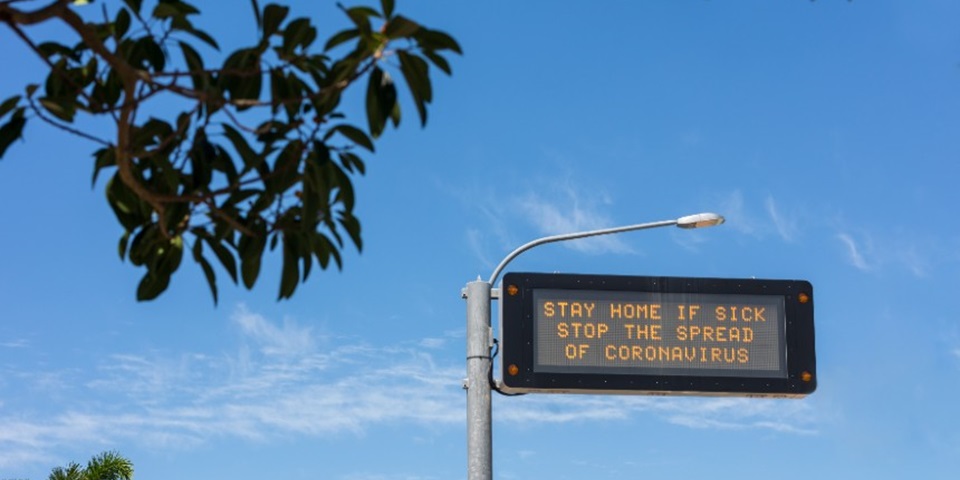 COVID-19 stay home warning road sign