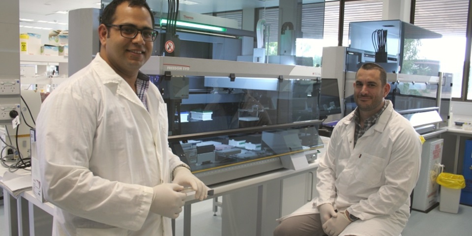 Associate Professor Sam Abraham and Dr Mark O?Dea standing near lab machinery